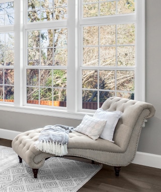 a sofa sitting next to a window representing interior home design and remodel