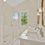 a beautiful cozy and newly remodeled bathroom near Idylwood VA with quartz vanity top and glass walk-in shower doors
