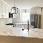 the inside of new kitchen remodeling project with beautiful white countertops and end peninsula